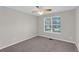 Bedroom with neutral colors and natural light from a bright window at 50 Riverside Ct, Hampton, GA 30228