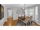 Spacious dining room featuring hardwood floors and natural light from large bay window at 50 Riverside Ct, Hampton, GA 30228