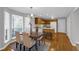 Sunlit dining area with hardwood floors and a view of the backyard through the bay window at 50 Riverside Ct, Hampton, GA 30228