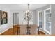 Open dining room with modern chandelier, hardwood floors, and natural light at 50 Riverside Ct, Hampton, GA 30228