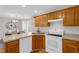 Kitchen featuring wood cabinets and white appliances at 50 Riverside Ct, Hampton, GA 30228