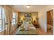 Serene bedroom with natural light, neutral tones, and a cozy bench at the foot of the bed at 5288 Mulberry Pass Ct, Hoschton, GA 30548