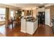 Modern kitchen island with sleek countertops, black appliances, and an adjacent dining area at 5288 Mulberry Pass Ct, Hoschton, GA 30548