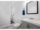 Modern bathroom featuring a gray vanity and a black framed mirror at 872 Beryl Sw St, Atlanta, GA 30310