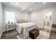 Cozy bedroom with neutral tones, hardwood floors, and a view into the bathroom at 872 Beryl Sw St, Atlanta, GA 30310