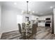 Dining area with modern chandelier open to the kitchen featuring stainless steel appliances at 872 Beryl Sw St, Atlanta, GA 30310