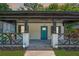 Charming home featuring a blue front door and inviting front porch with decorative railing at 872 Beryl Sw St, Atlanta, GA 30310