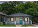 Charming home featuring a blue front door and inviting front porch with decorative railing at 872 Beryl Sw St, Atlanta, GA 30310