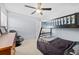 bedroom featuring a bunk bed, ceiling fan, window, and a black gaming chair at 1191 Fountain Head Ct, Lawrenceville, GA 30043