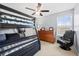 bedroom featuring a bunk bed, ceiling fan, window, and a black gaming chair at 1191 Fountain Head Ct, Lawrenceville, GA 30043