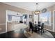 Cozy dining area with a round table, hardwood floors, a ceiling fan, and a view of the living room at 1191 Fountain Head Ct, Lawrenceville, GA 30043