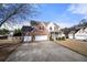 Charming two-story home with brick facade, manicured landscaping, and a three-car garage at 1191 Fountain Head Ct, Lawrenceville, GA 30043