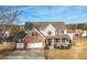 Attractive two-story home with a brick facade, a well-manicured lawn, and a spacious driveway at 1191 Fountain Head Ct, Lawrenceville, GA 30043