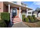 Inviting front porch with red-painted steps and white railings, framed by lush green bushes at 1191 Fountain Head Ct, Lawrenceville, GA 30043