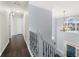 Hallway overlooking the foyer showcasing a decorative railing and wood flooring at 1191 Fountain Head Ct, Lawrenceville, GA 30043