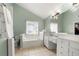 Relaxing main bathroom with a soaking tub, double sinks, tile floors, and bright lighting at 1191 Fountain Head Ct, Lawrenceville, GA 30043