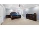 Expansive main bedroom with a tray ceiling, carpet flooring, and dark wood furniture at 1191 Fountain Head Ct, Lawrenceville, GA 30043