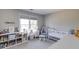 Bright Bedroom featuring a white crib, a comfy chair, and a bookshelf filled with colorful books and toys at 5446 Oxford Chase Way, Dunwoody, GA 30338