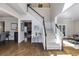 Grand foyer showcasing hardwood floors, a staircase, and views into the dining room and living spaces at 5446 Oxford Chase Way, Dunwoody, GA 30338