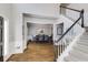 Elegant foyer with hardwood floors, staircase, and views of the dining area, creating a welcoming entrance at 5446 Oxford Chase Way, Dunwoody, GA 30338