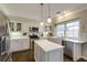 Modern kitchen featuring stainless appliances, white cabinets and island with pendant lights at 5446 Oxford Chase Way, Dunwoody, GA 30338