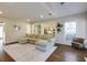 Bright living room featuring a large sectional sofa, area rug and hardwood floors at 5446 Oxford Chase Way, Dunwoody, GA 30338