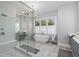 Bright bathroom featuring a shower, soaking tub, and dual sink vanity with white countertops and gray cabinets at 574 Boulevard Ne Pl # 5, Atlanta, GA 30308