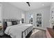 Inviting main bedroom with a large bed, white brick accent wall, and balcony access at 574 Boulevard Ne Pl # 5, Atlanta, GA 30308