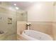 Luxurious bathroom featuring a separate glass enclosed shower and large soaking tub at 78 Paces West Nw Cir, Atlanta, GA 30327