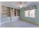 Bright bedroom featuring custom built in bookshelves and large windows at 78 Paces West Nw Cir, Atlanta, GA 30327