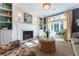 Elegant living room featuring a fireplace, built-in bookshelves, and a large window with natural light at 78 Paces West Nw Cir, Atlanta, GA 30327