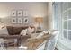 Well-lit living room showcasing a cozy sofa, patterned armchair, and large windows at 78 Paces West Nw Cir, Atlanta, GA 30327