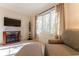 Comfortable living room featuring a large window, media console, and cozy seating area at 78 Paces West Nw Cir, Atlanta, GA 30327