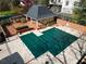 Aerial view of a pool covered with a green tarp and an adjacent building at 78 Paces West Nw Cir, Atlanta, GA 30327