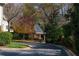 A view of the street with mature trees, landscaping and a covered structure at 78 Paces West Nw Cir, Atlanta, GA 30327