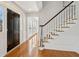 Welcoming entryway with hardwood floors, staircase, and a view into the adjacent living space at 1780 Redbourne Dr, Sandy Springs, GA 30350