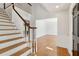 Bright foyer features hardwood floors, a staircase with white risers and a black front door at 1780 Redbourne Dr, Sandy Springs, GA 30350