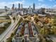 Aerial view of a townhouse community near the Atlanta skyline and major roadways at 375 Highland Ne Ave # 908, Atlanta, GA 30312