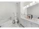 Bathroom with marble tile, soaking tub, and double vanity at 375 Highland Ne Ave # 908, Atlanta, GA 30312