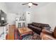 Open concept living area with hardwood floors, ceiling fan and a partial view of the kitchen at 375 Highland Ne Ave # 908, Atlanta, GA 30312