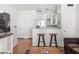 Living room area with kitchen breakfast bar and hardwood flooring at 375 Highland Ne Ave # 908, Atlanta, GA 30312