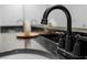 A close-up of a sleek, black faucet against a granite countertop and sink at 390 17Th Nw St # 1063, Atlanta, GA 30363
