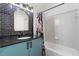 Stylish bathroom featuring blue tiled accent wall, black granite countertops, and a shower/tub combo at 390 17Th Nw St # 1063, Atlanta, GA 30363