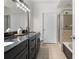 Bathroom with double sink vanity, granite countertops, and a glass enclosed shower at 390 17Th Nw St # 1063, Atlanta, GA 30363