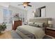 Comfortable bedroom with large bed, shuttered windows, and a ceiling fan at 390 17Th Nw St # 1063, Atlanta, GA 30363