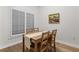Cozy dining area featuring a wooden table with seating for four and bright natural light from shuttered windows at 390 17Th Nw St # 1063, Atlanta, GA 30363