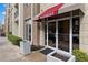The building's entrance has a welcoming awning, easy access to shops, and attractive landscaping at 390 17Th Nw St # 1063, Atlanta, GA 30363