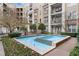 Courtyard water feature, surrounded by lush landscaping in a multi-story brick apartment complex at 390 17Th Nw St # 1063, Atlanta, GA 30363