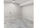 Clean unfinished basement with marbled tile floor at 8160 Stone Hill Rd, Cumming, GA 30028