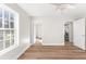 Empty bedroom with hardwood floors, ceiling fan, and lots of natural light at 8160 Stone Hill Rd, Cumming, GA 30028